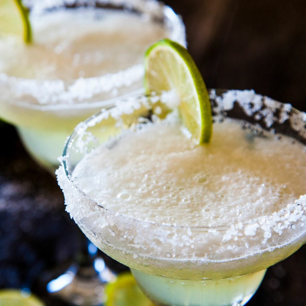 a pair of margaritas with salted rims