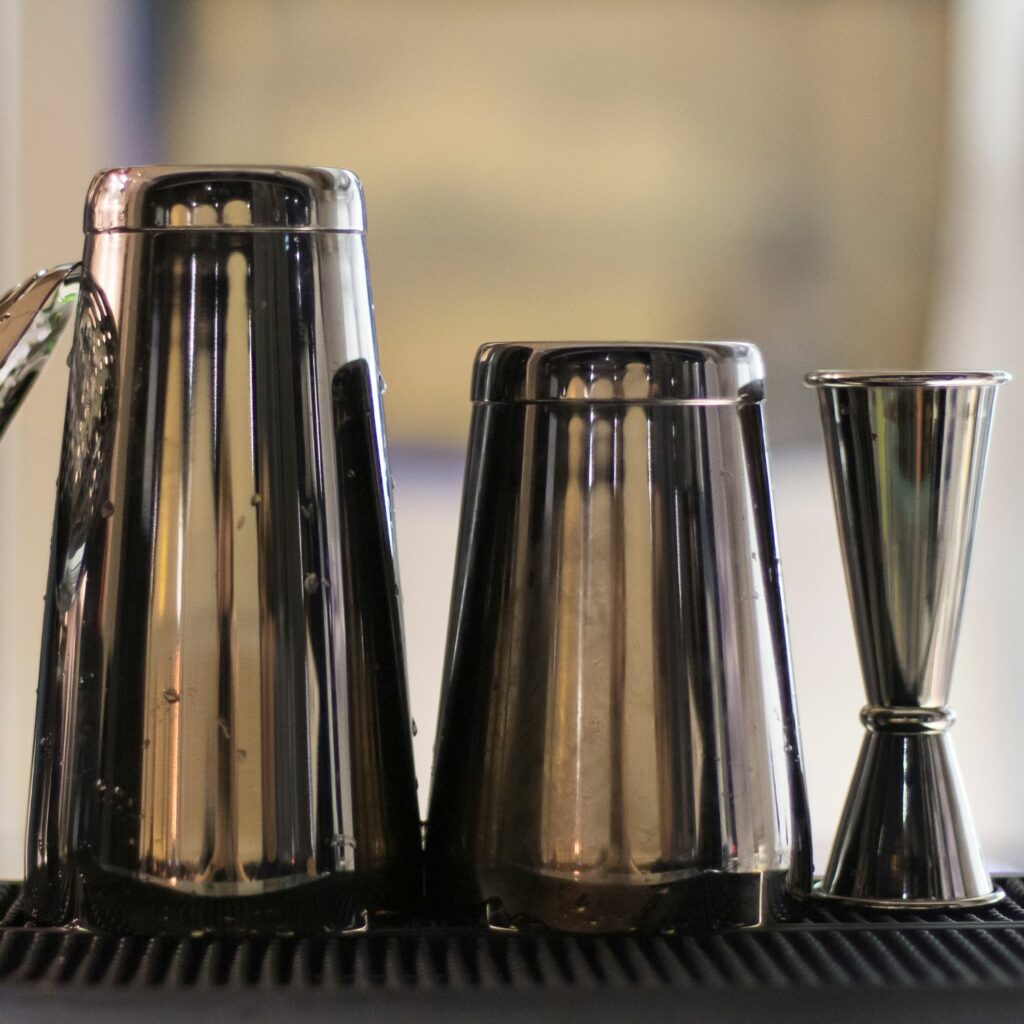 cocktail tools sitting on a bar
